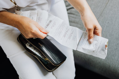Woman checking her receipt paper